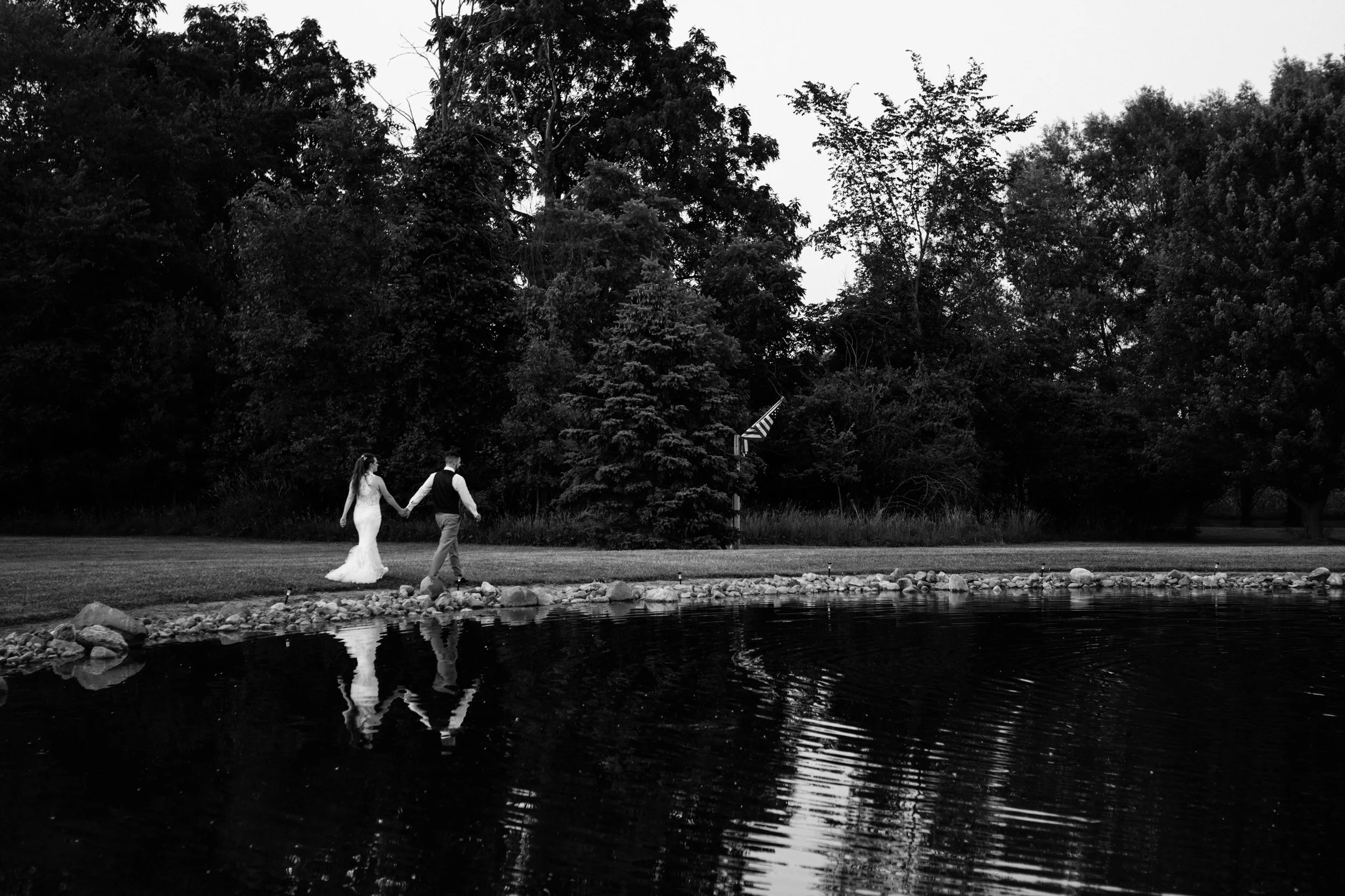 Bride +Groom Black and White Photo by lake | Summer Weddings | Michigan Wedding Photography | Wedding Coverage | East Lansing Okemos Perry Brighton Wedding Photos | Female Photographer | LGBTQ+ Friendly Photographers | Williamston Studio