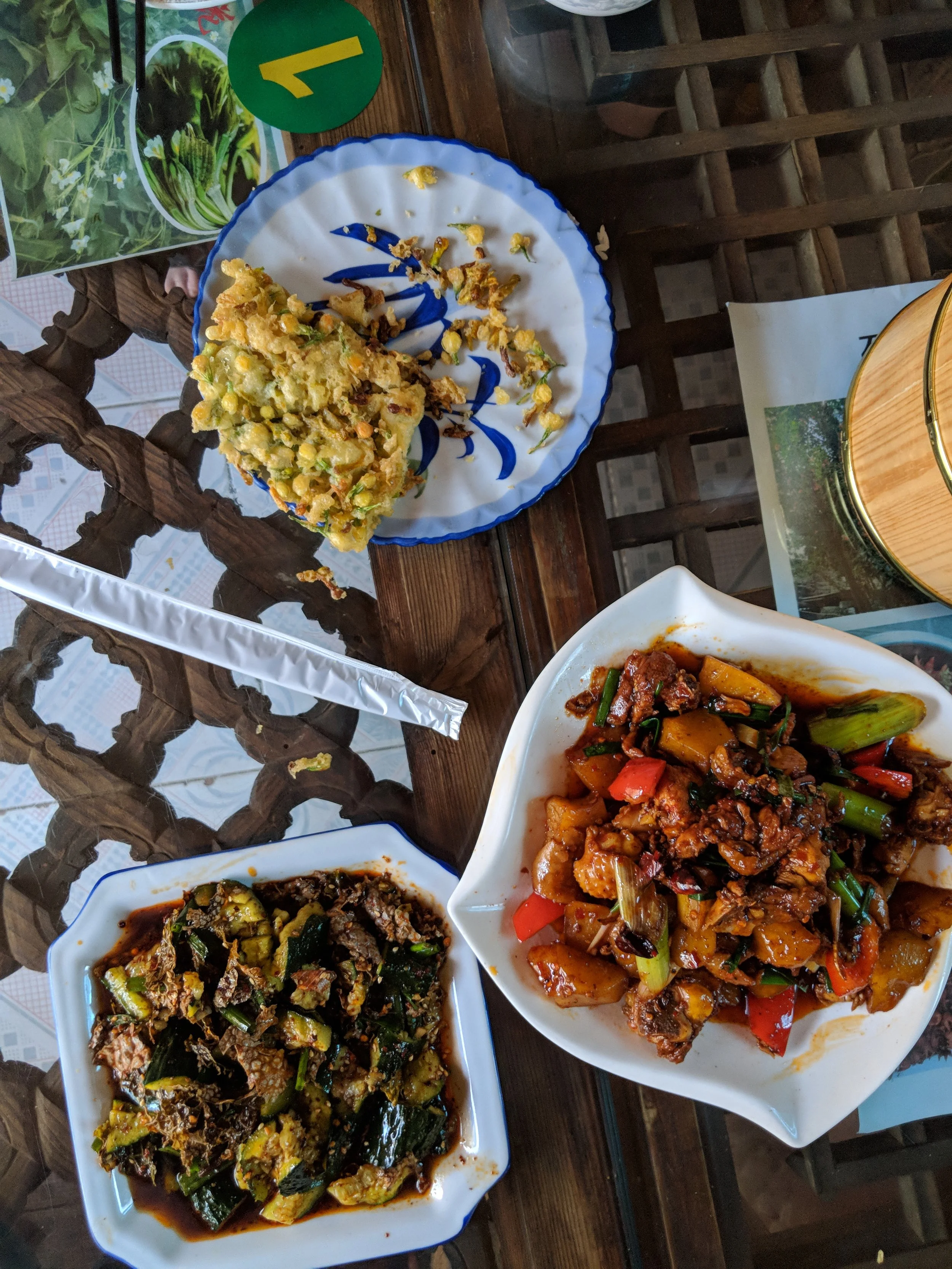 Another dinner served in Dali, featuring local vegetables, lichen from the mountains and a jasmine flower omelette. 