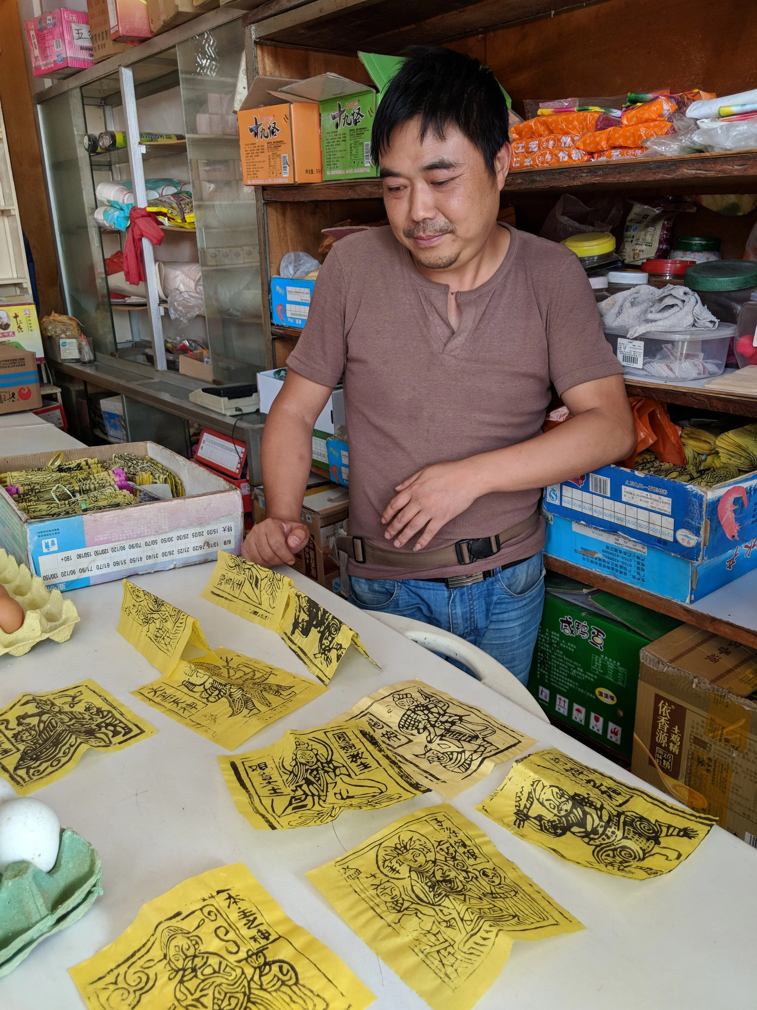 Zhang Qing Shen carves jia ma woodblocks to print benzhus, small papers that locals burn at temples for luck and good fortune. 