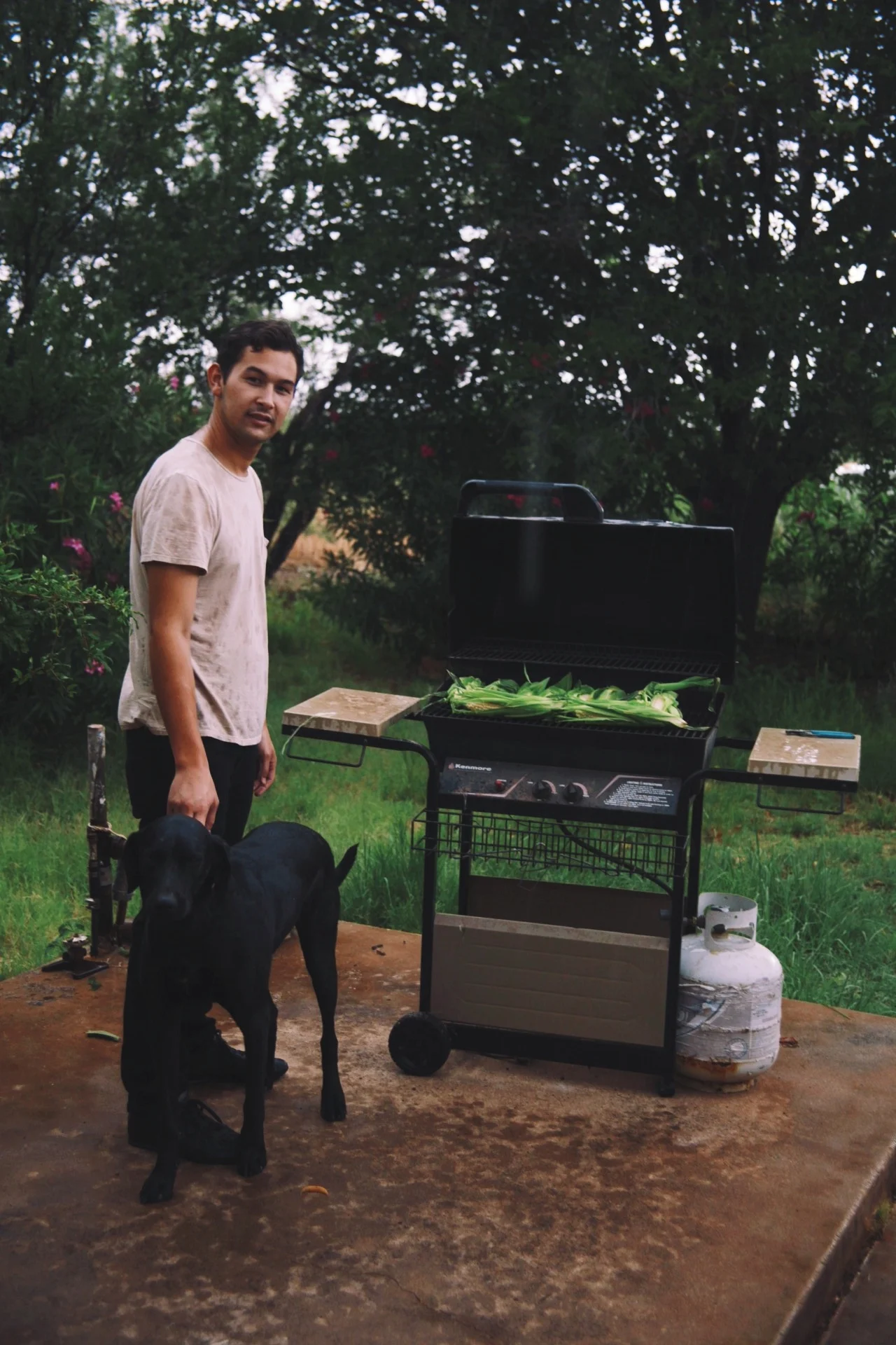 BBQing in the rain with my dog Chuck.