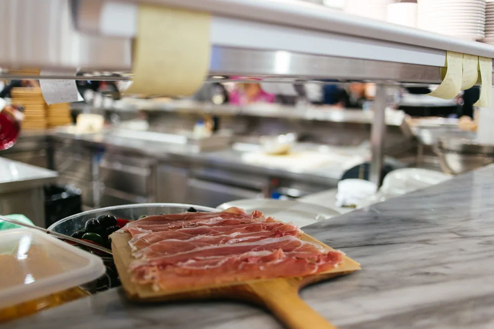 Freshly sliced prosciutto in EATaly's fresh meat and cheese area