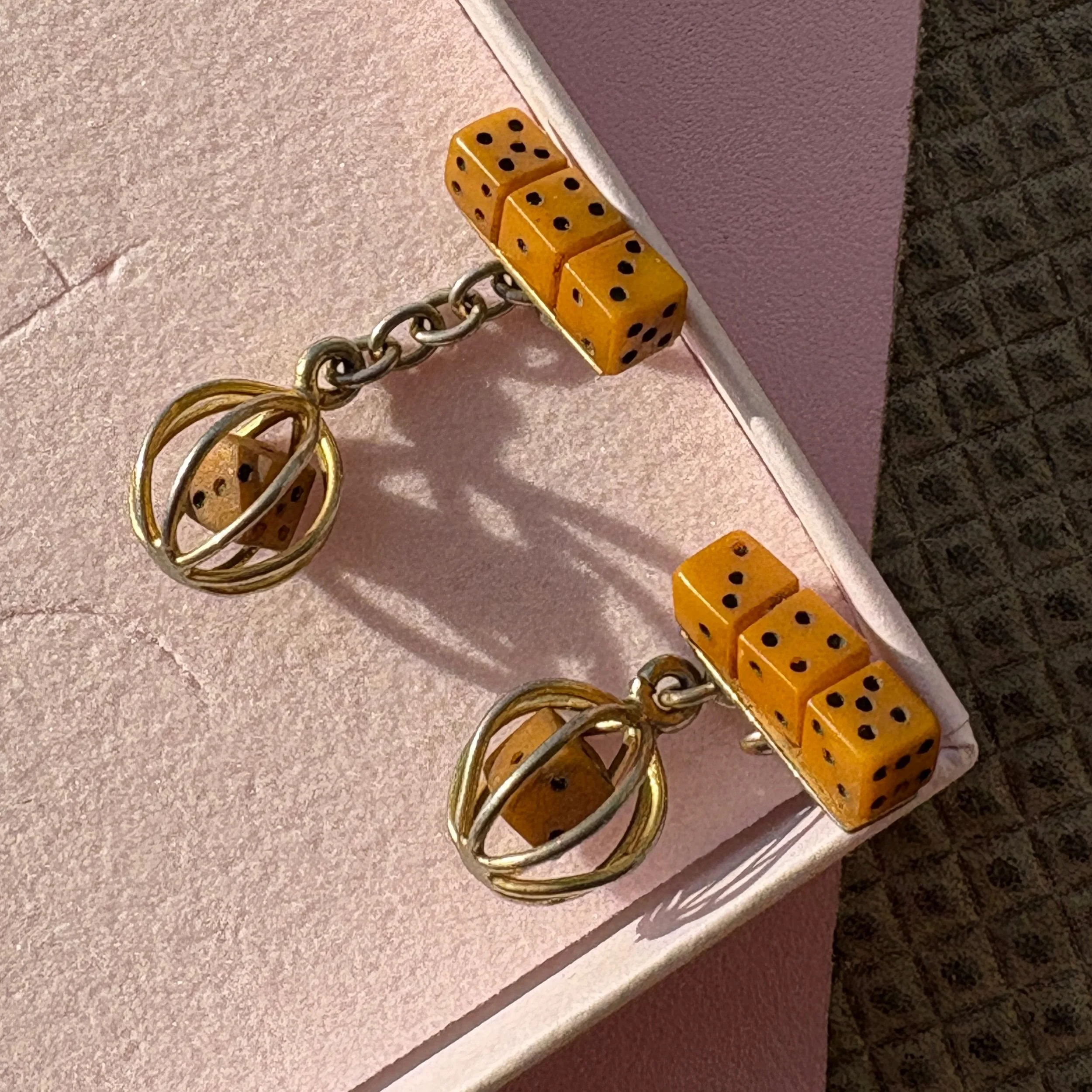 JUST SO GOOD! I found these Art Deco Bakelite cufflinks at a brocante in France. I was rummaging in a box and found one, and then kept rummaging and found the other 🙏🏽👏🏼 One side of the cufflink holds three tiny Bakelite dice, and the other has a