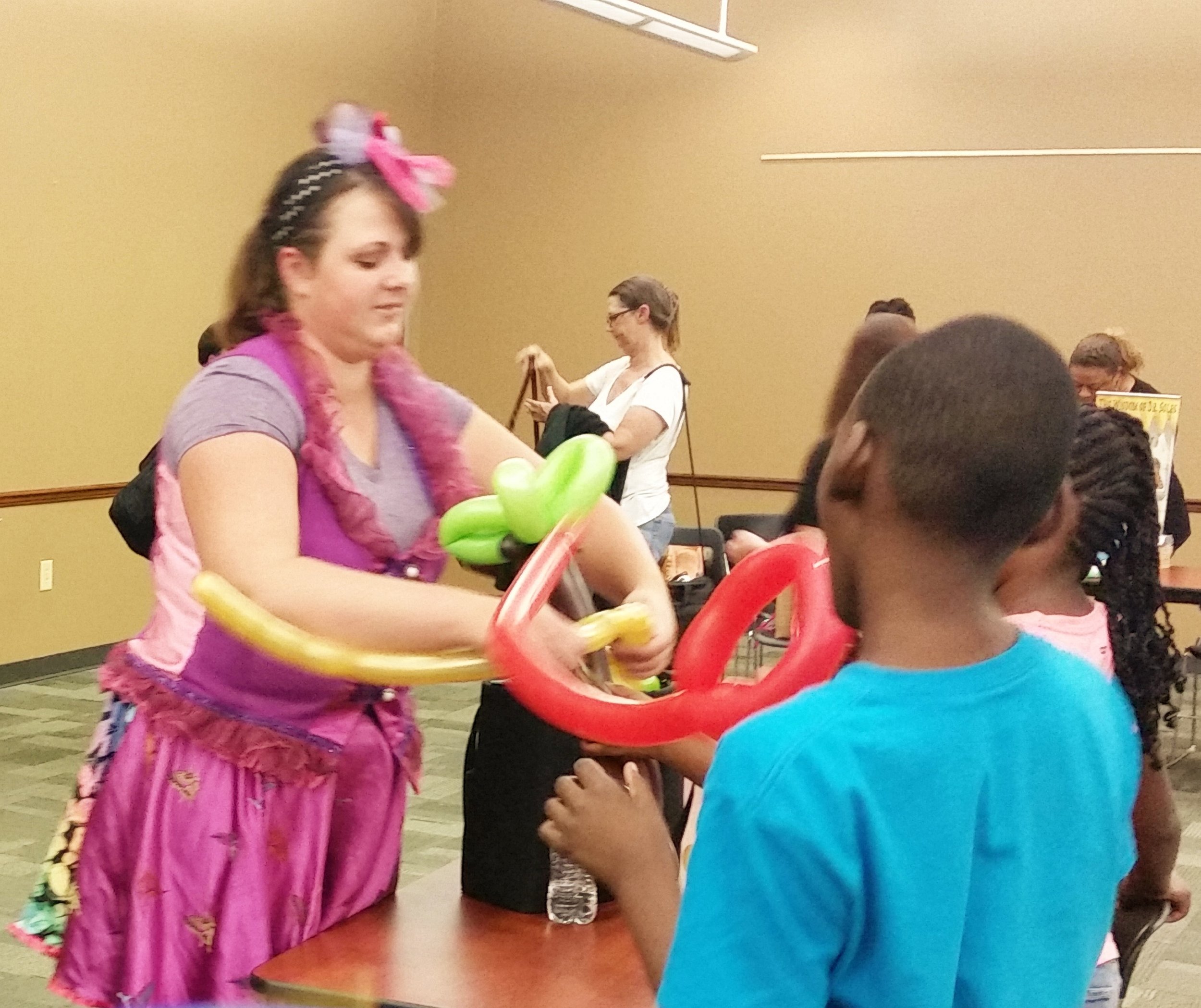 Waiting patiently while the balloon artist works her magic.