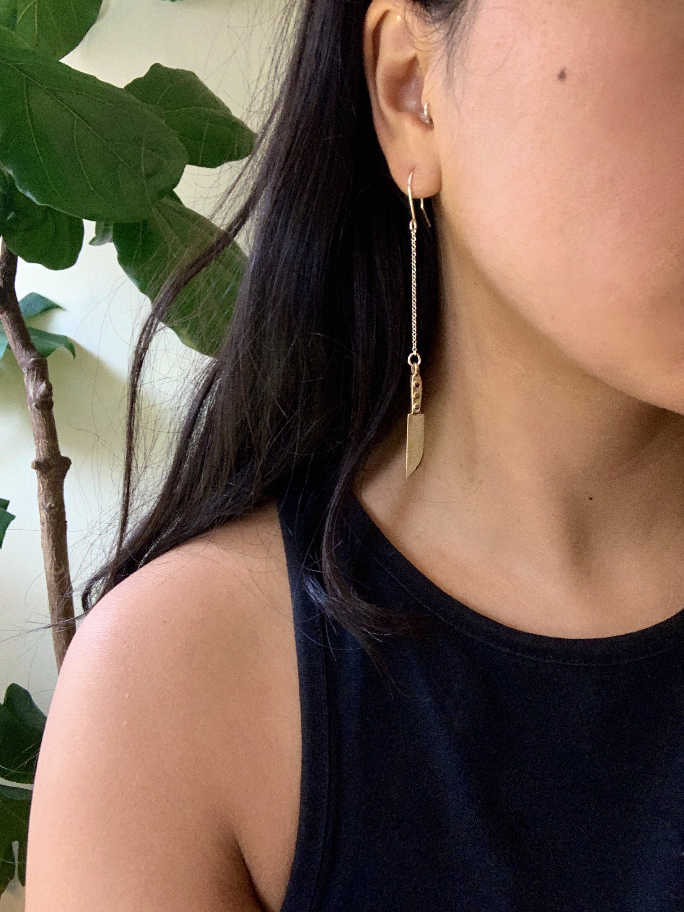 woman modelling knife earring with chains