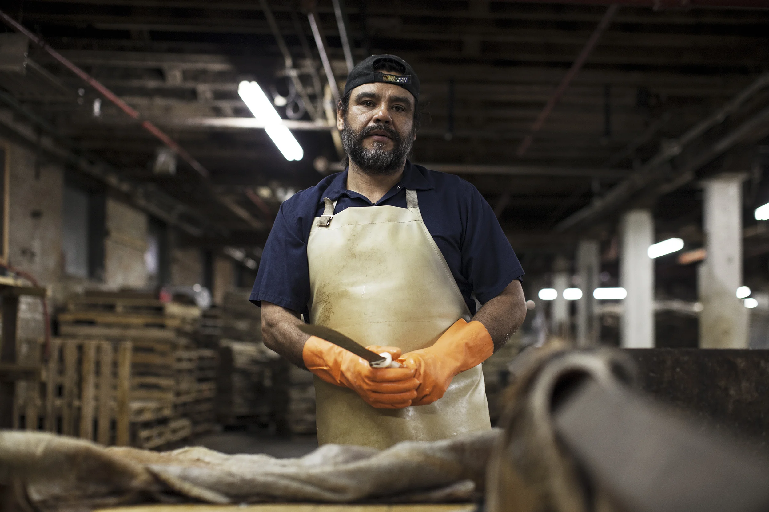  A work with his blade used for cutting and stripping heavy pieces or hide. 