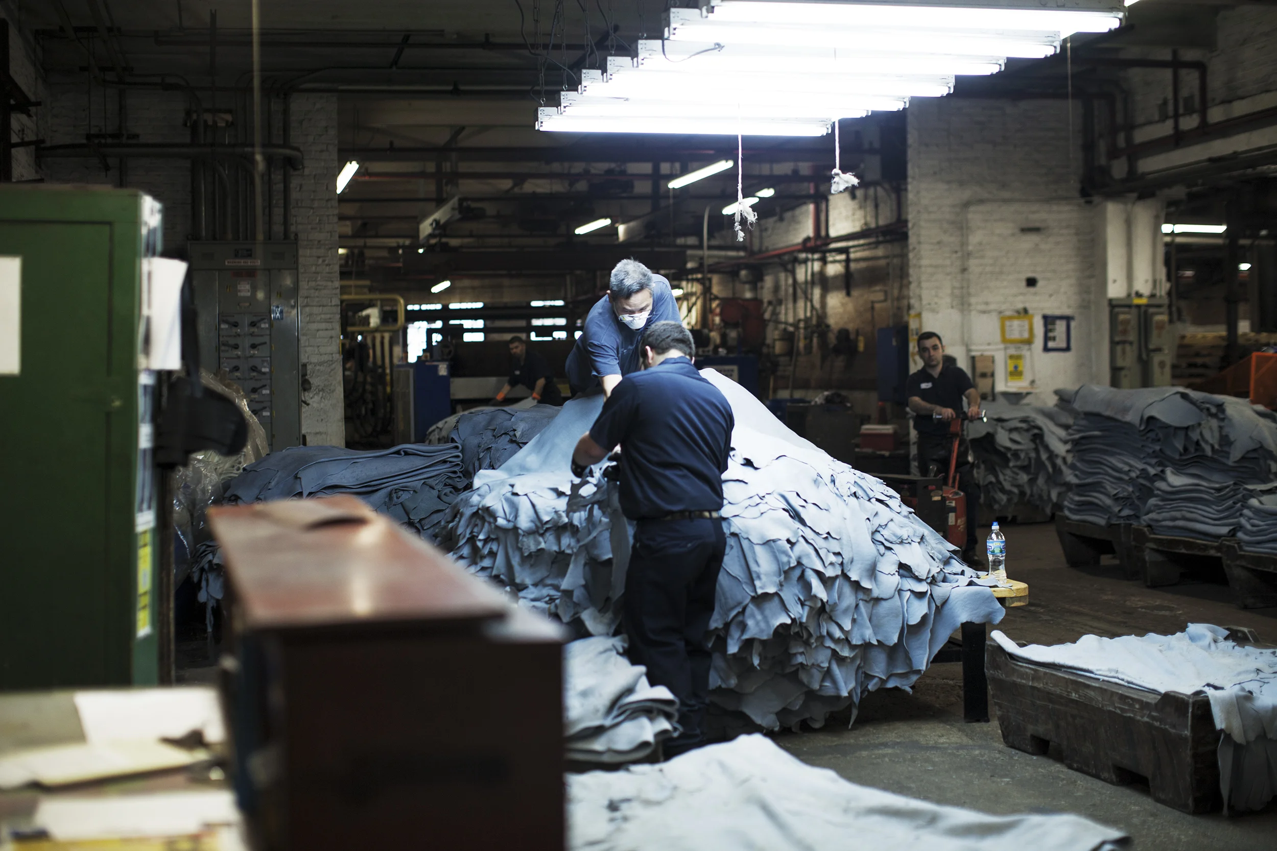  Strips of dyed leather being stacked. 