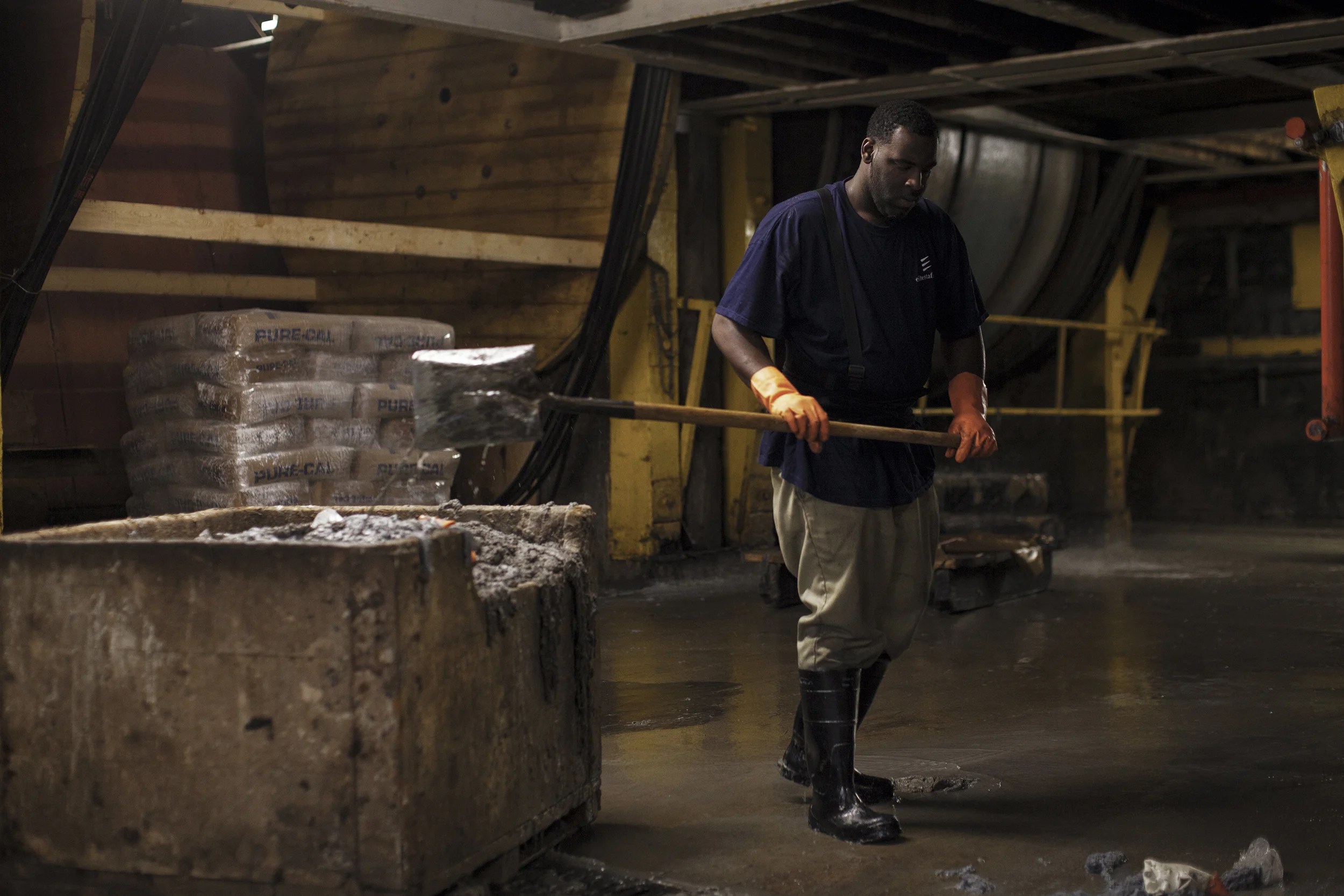 A worker cleaning up a dirty area in one of the processing rooms where leather goes through a full cleaning treatment before getting dyed or conditioned.