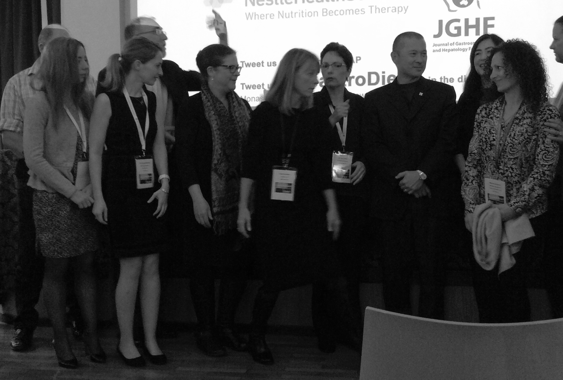 Dr. Peter Gibson organizing the speaker photo on the last afternoon of the conference--a little like herding cats.