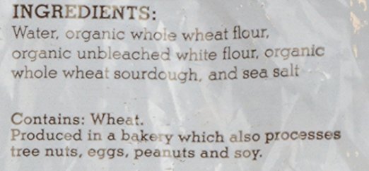 This bread looks more like the real deal. Good signs: 1) no references to any ingredients like vinegar that would be used to make the bread taste sour 2) no yeast in the list of ingredients. (The word "sourdough" is a bonus in the list of ingredients, but is not essential. Many authentic sourdough breads don't even mention that word on either the front or the back of the food label and fake sourdoughs will use the word to describe flavor only.)