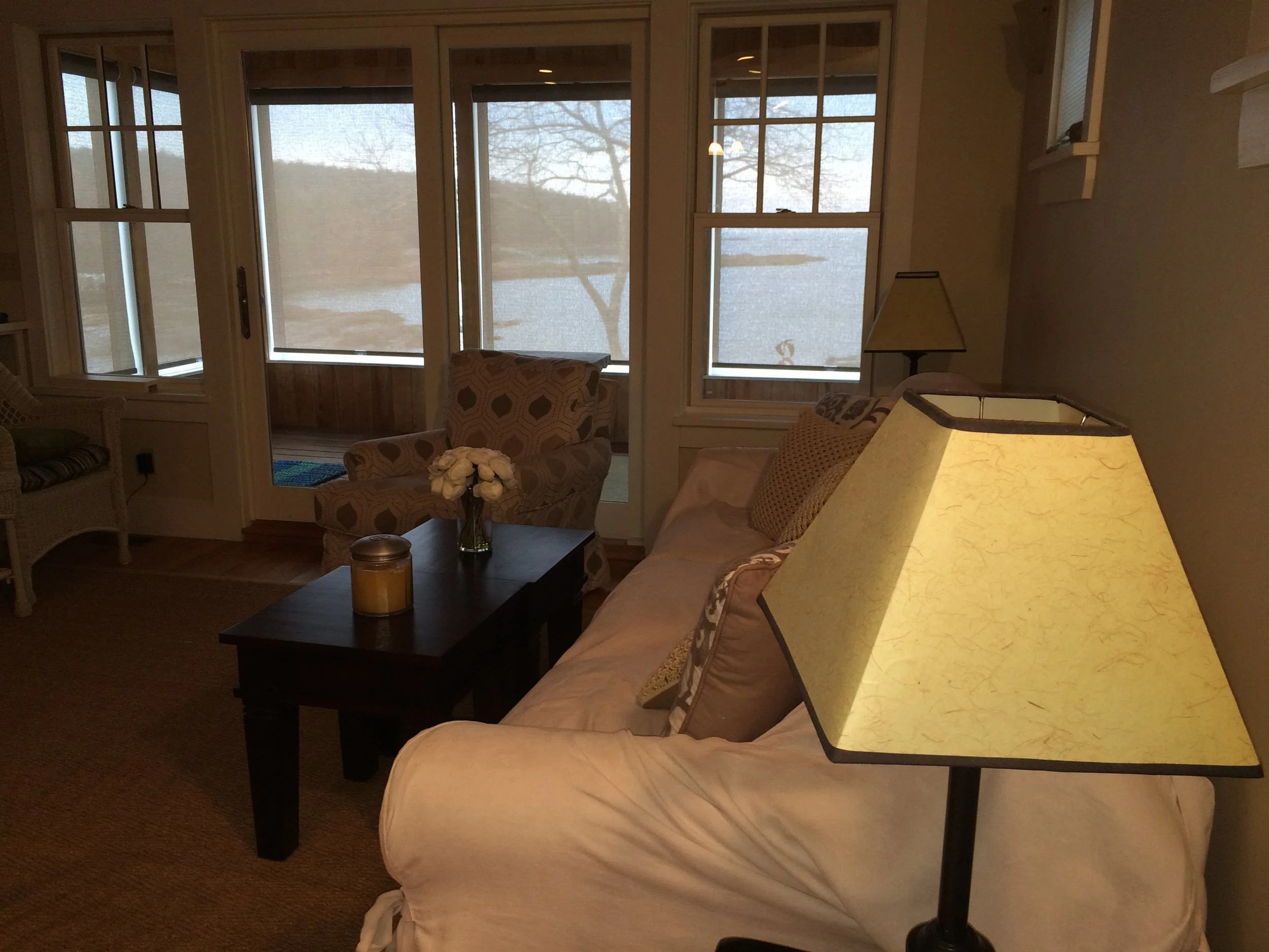 View of living and sun room with solar shades