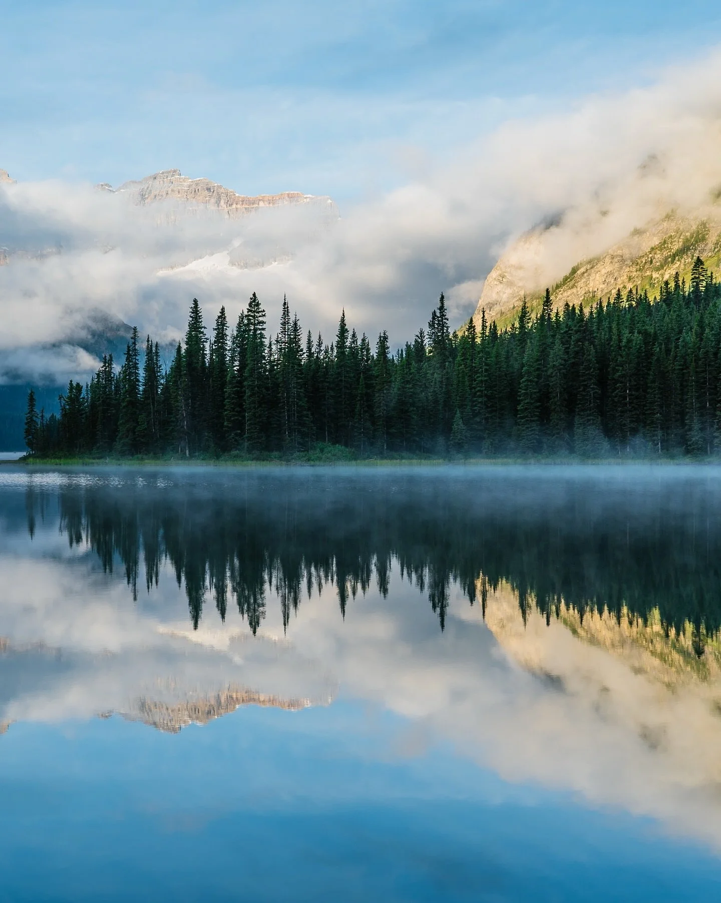 DAWN BROKE over the Canadian Rockies as we rose above Marvel Lake, the helicopter skimming through clouds soft as cotton. Below, the water mirrored the fire of sunrise, mountains wrapped in silence older than time itself. We filmed for Still Wild, bu