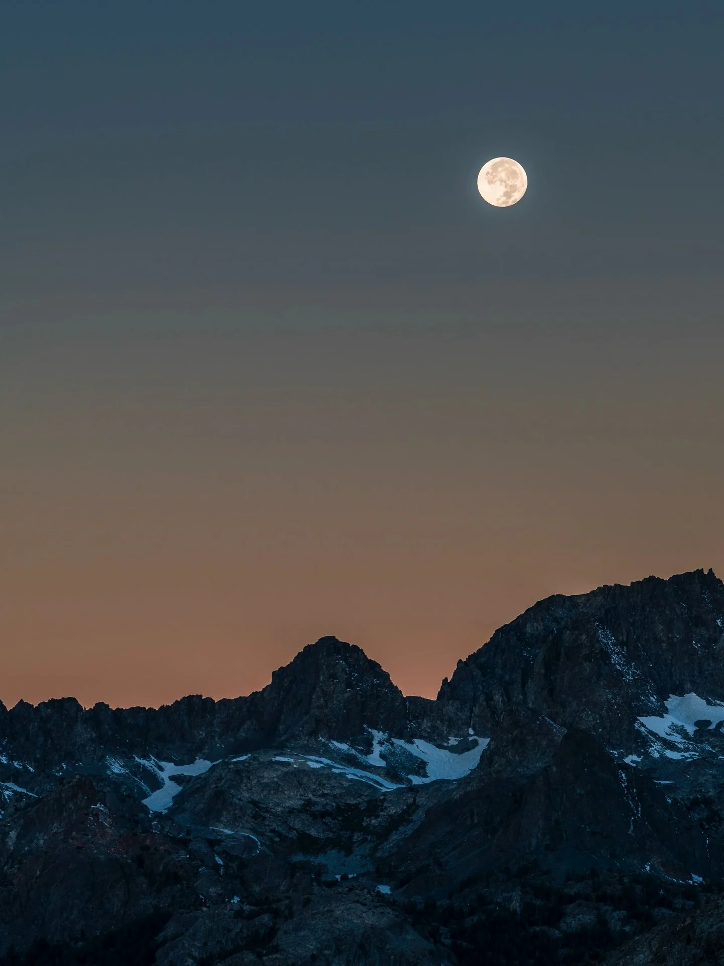Staring out at a full moon just before sunrise at The Minarets, the moon glowing pale and steady above serrated stone, the peaks still holding the night as the first breath of morning begins to rise behind them.

Circa 2017 @lonebison  #wearestillwil