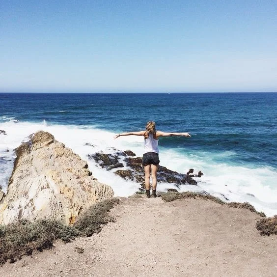Standing on a cliff above the ocean