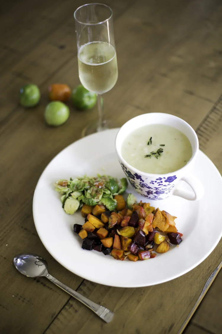 A bowl of soup with roasted vegetables