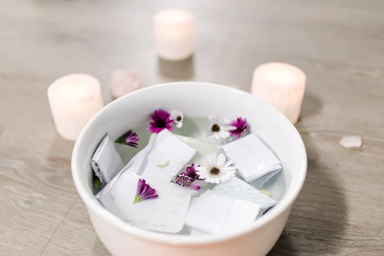 A bowl of flowers with candles