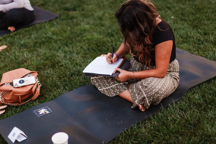 Writing on a mat at an outdoor class