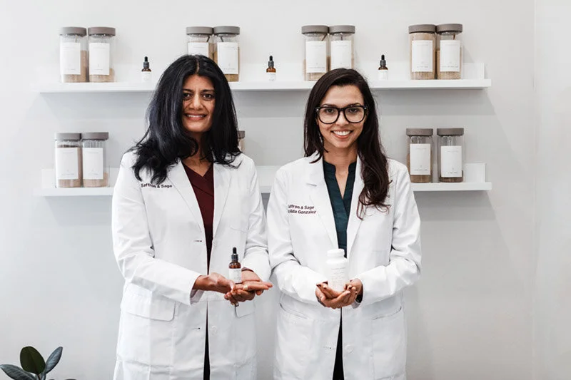 Two Saffron & Sage doctors working together at the clinic