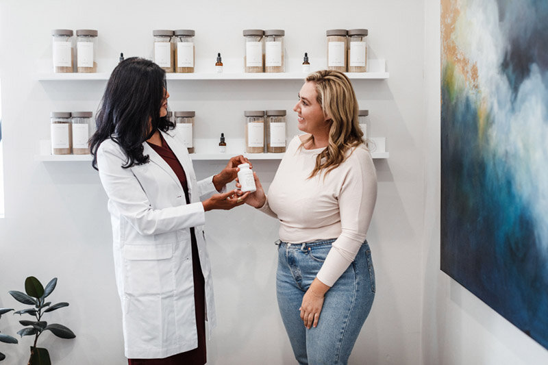 A practitioner and client in the apothecary