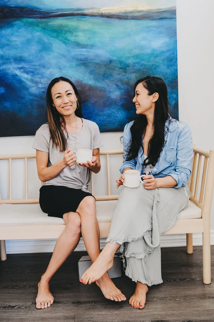 Two friends laughing on a bench
