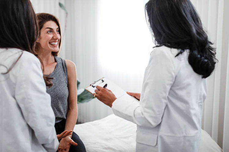 A practitioner laughing with two clients