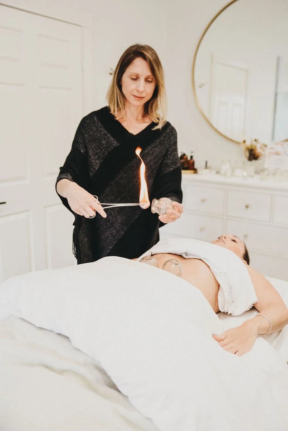 A practitioner working with warmth over a client