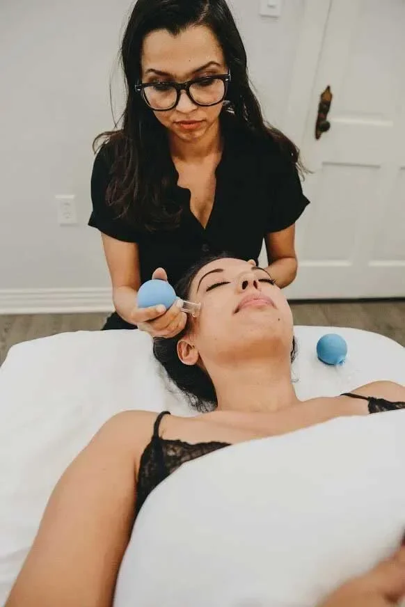 Facial cupping during a skincare session at Saffron & Sage in San Diego