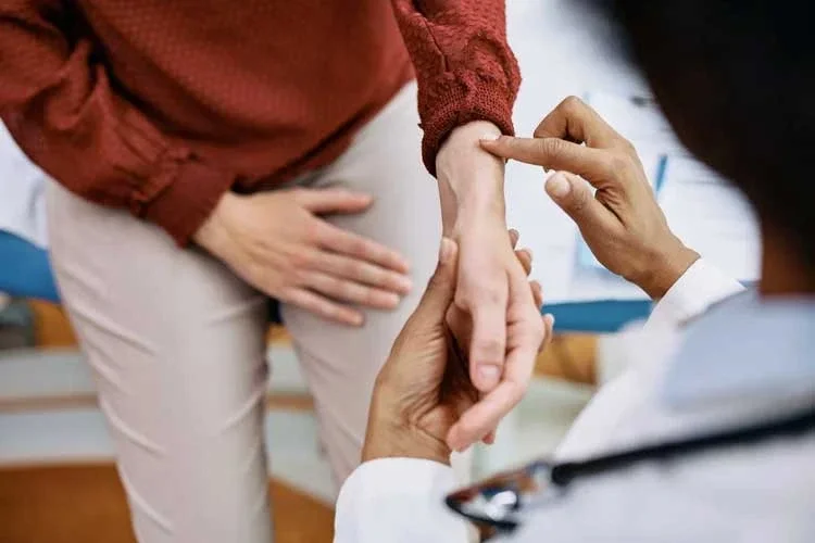 A practitioner taking a pulse at the wrist