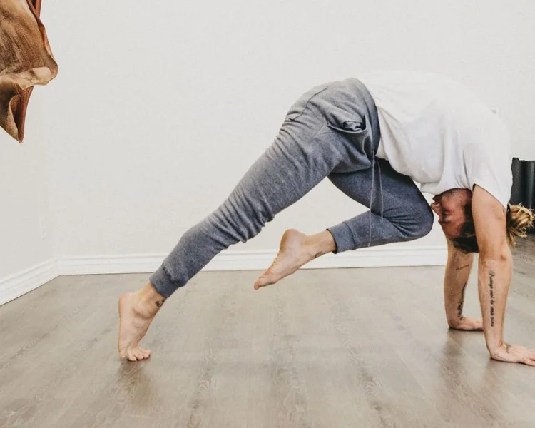 A man moving through a floor stretch