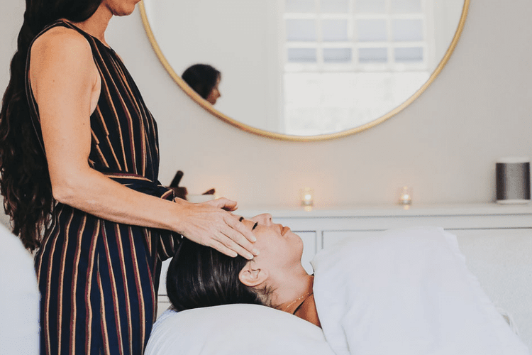 A practitioner supporting a client at the head