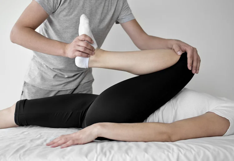 Assisted leg stretch with a massage tool