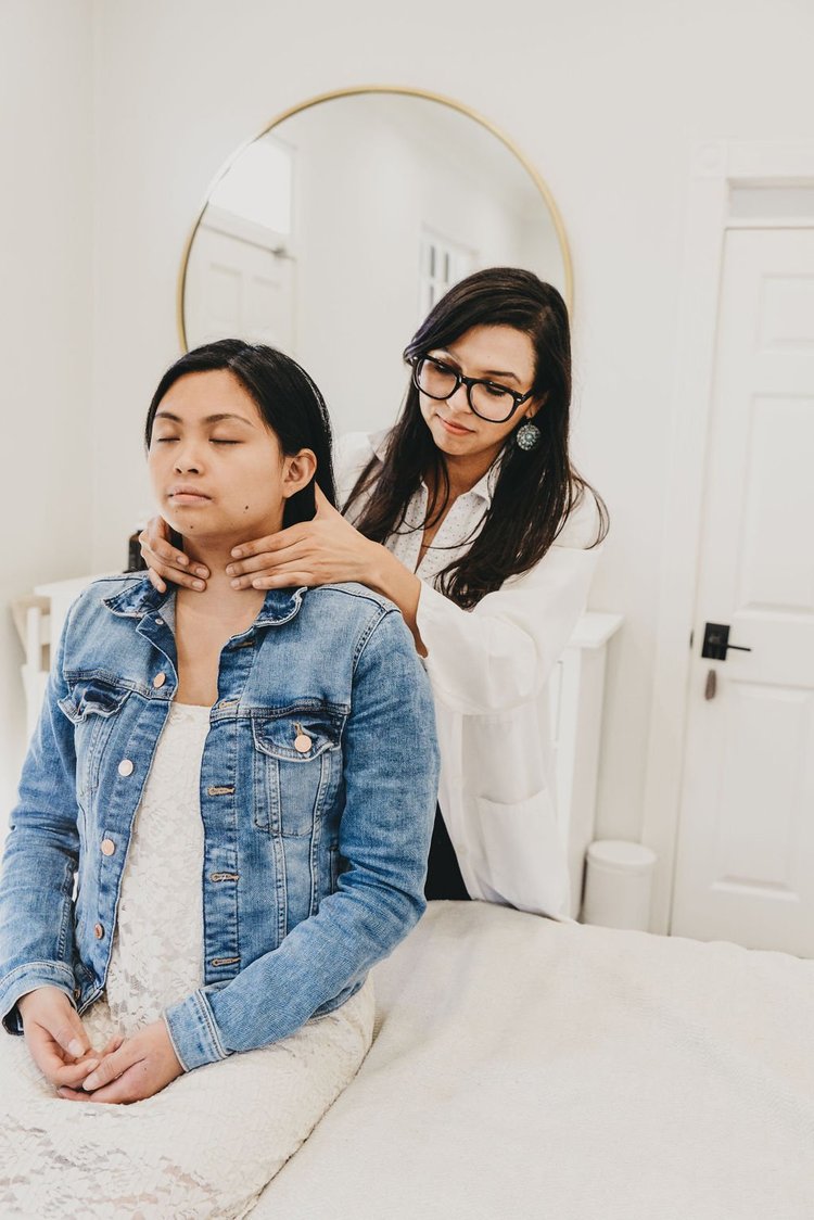 A practitioner checking the neck