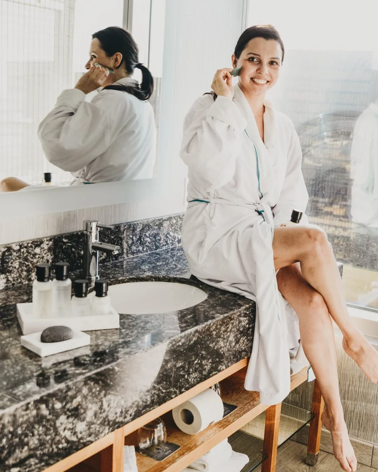 Sitting at the vanity in a robe
