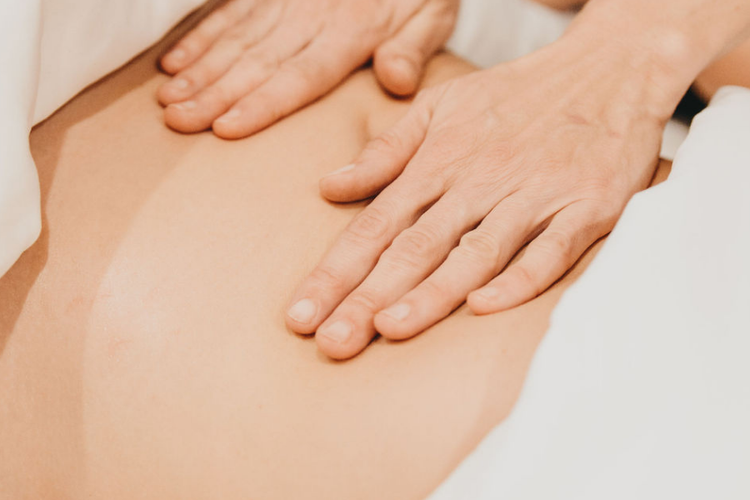 Hands working on the lower back