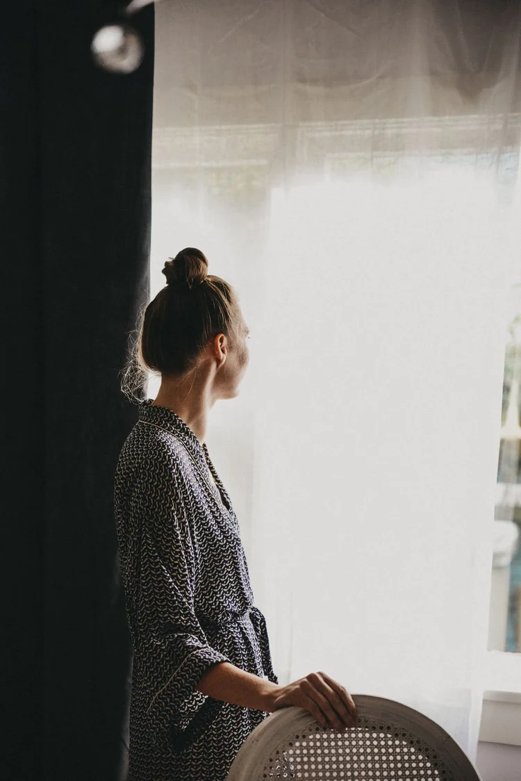 Standing quietly by a window