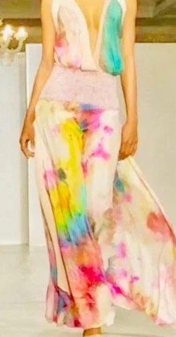 A person wearing a long, colorful, snow-dyed dress with pink, yellow, blue, and purple patterns.