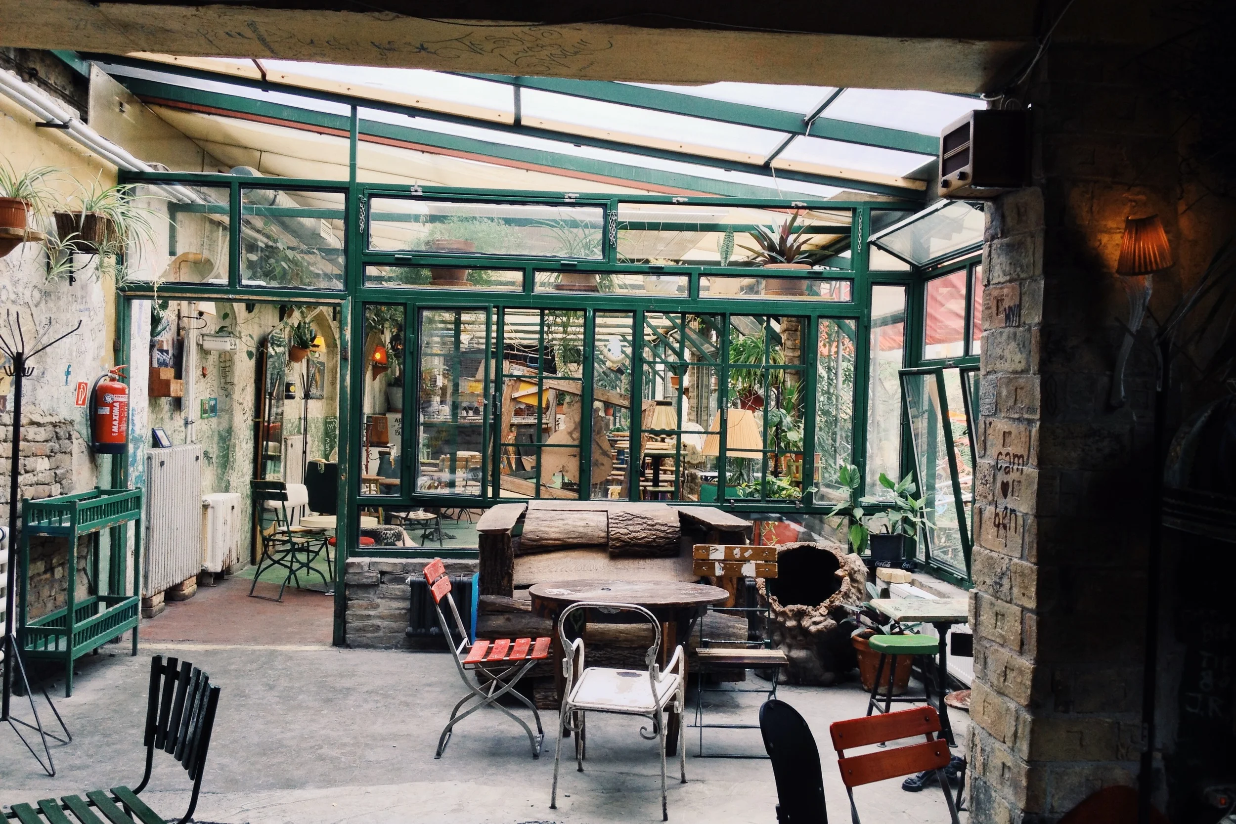 A daytime walk through Szimpla Kert, the popular bar that first kicked off the "Ruin Bar" movement that caught like wildfire in Budapest. In case you are wondering, "Ruin Bar" is short-hand for a bar whose aesthetic was determined by an "anything goes" mentality and items salvaged while dumpster diving. Think things like half-sawed off bath tubs, detached car chairs with the stuffing coming out of gashes in the fabric, marker graffiti on the walls, etc. 