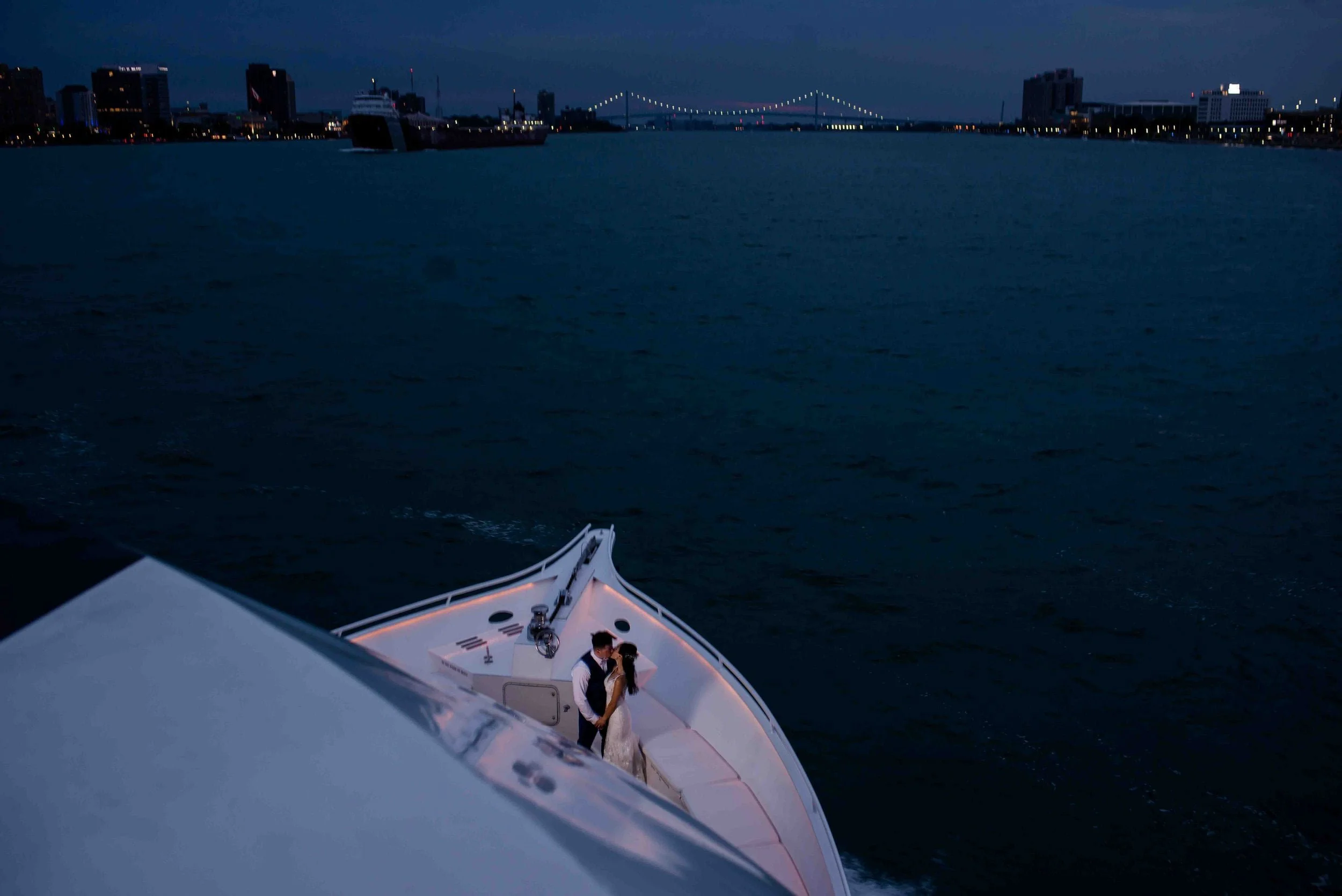 Bride and groom on Ovation yacht with Canada Bridge in the background, Detroit