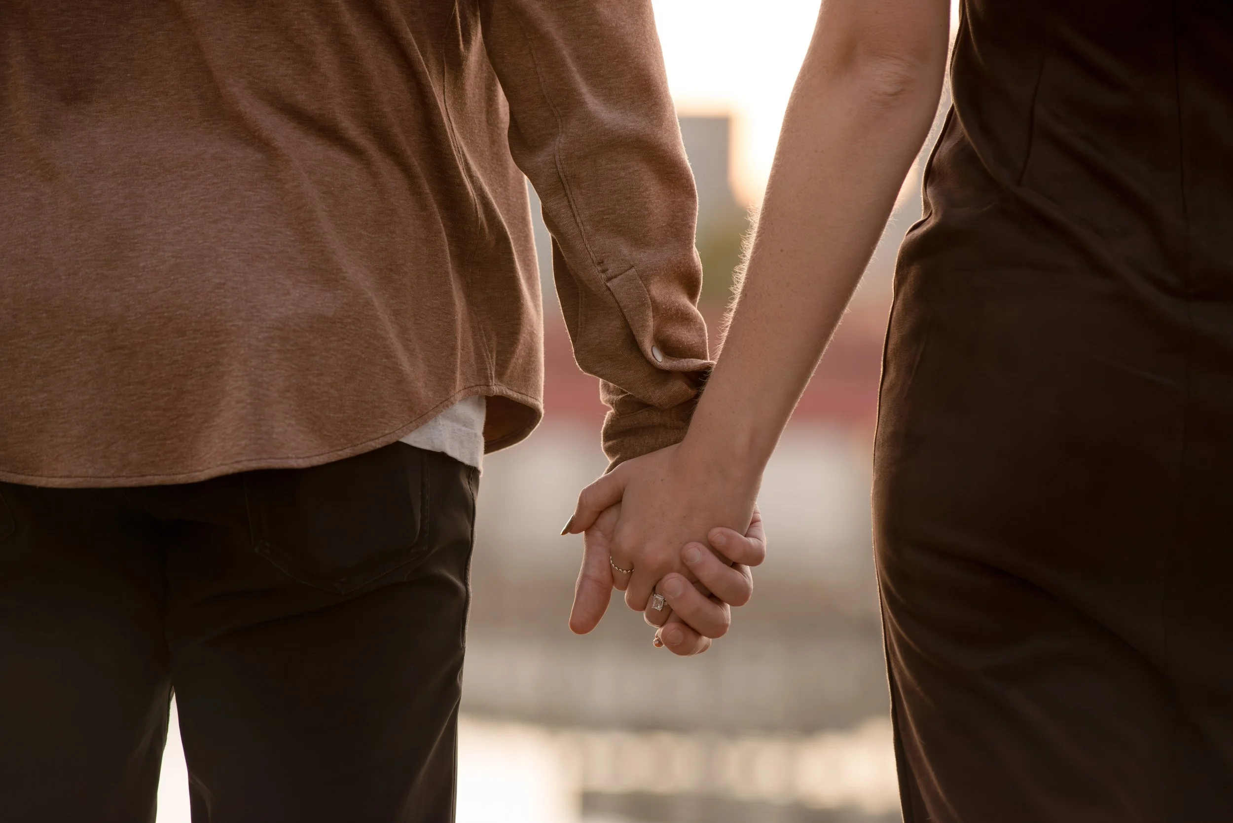 Close up engagement ring photo of couple holding hands after Michigan proposal