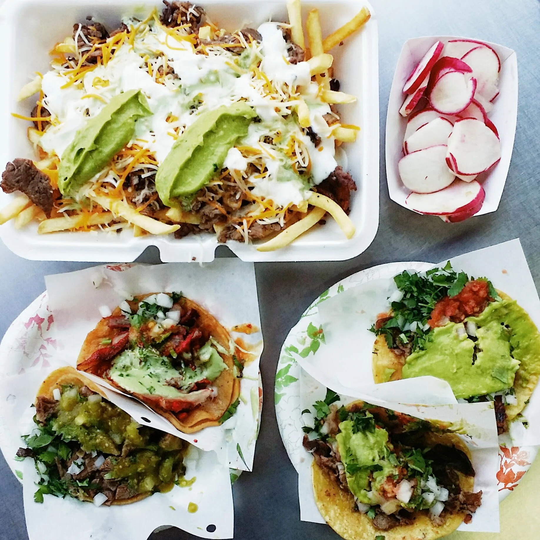 {Carne asada fries, al pastor taco, lengua taco, & carne asada tacos}