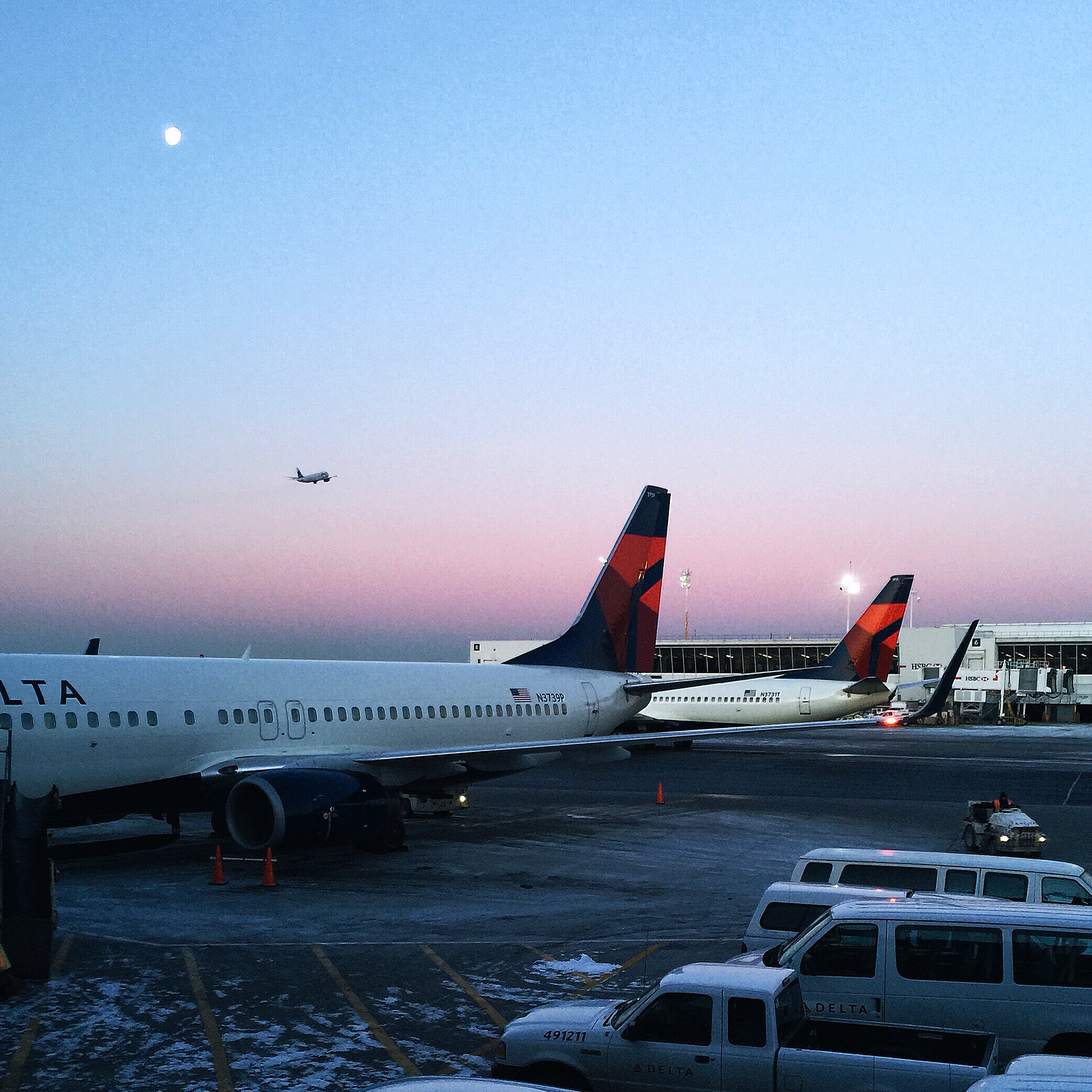   {the sunrise at JFK featuring the moon and a miniature airplane taking off.}  