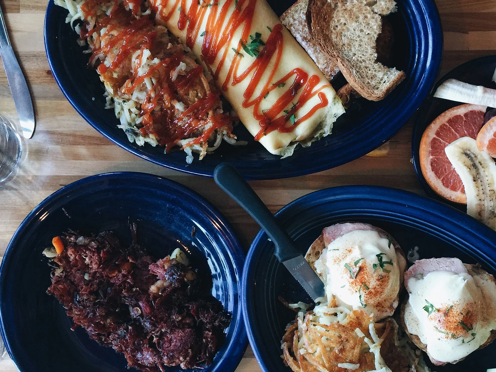{Corned beef hash, omelette, and eggs benedict.}
