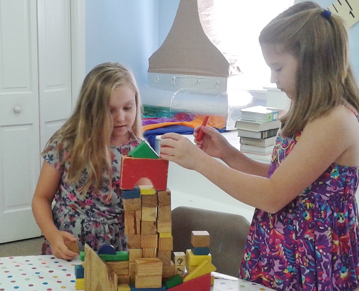 Charlotte and EllieLegette are working on their tower.