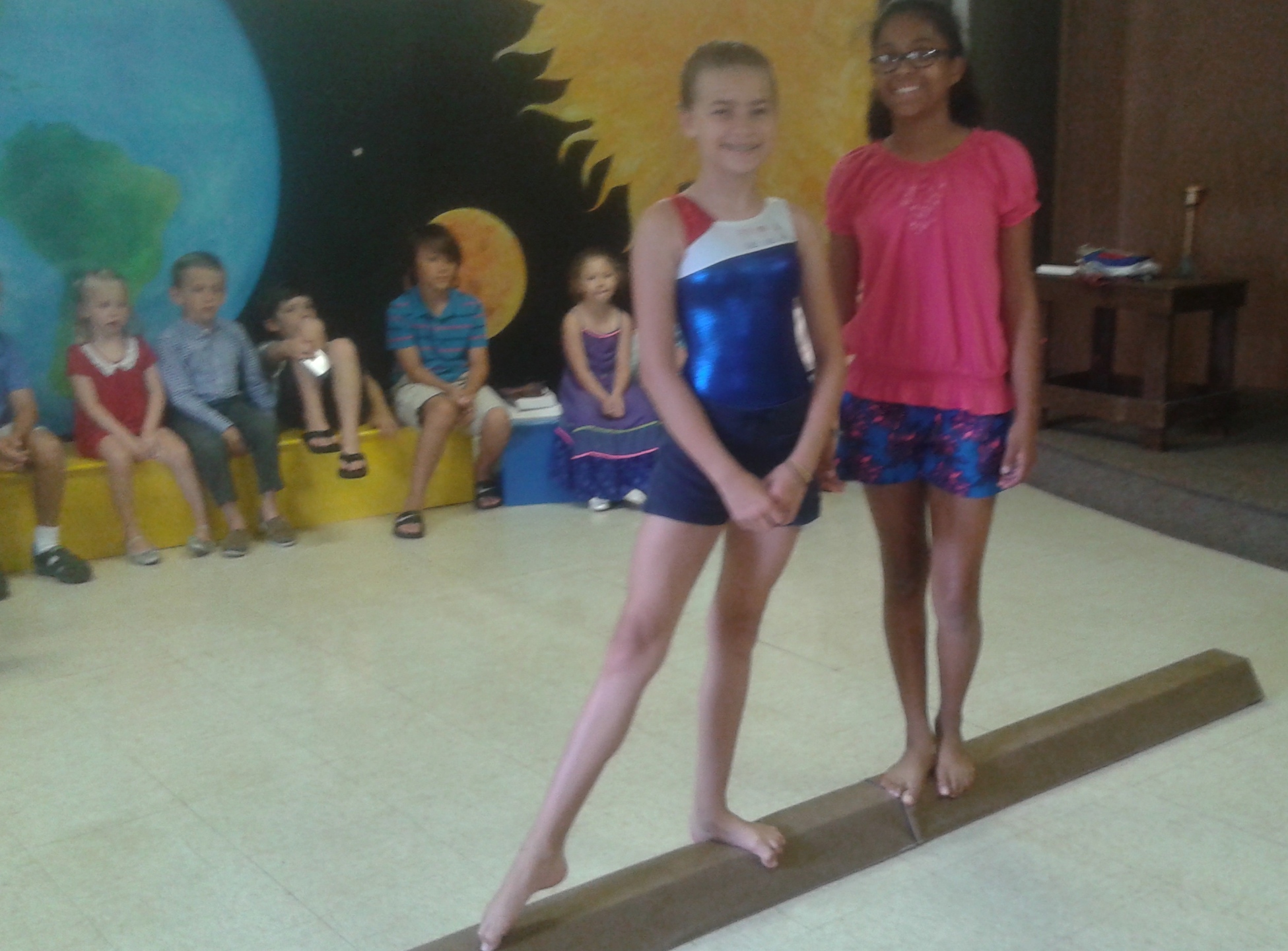Elena and Anna demonstrated the balance beam.
