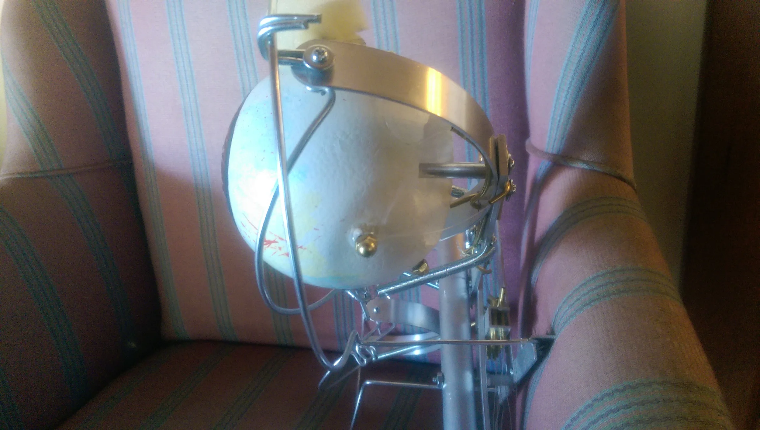 Back of the eye mechanism showing the pivot support shaft and the control line attachments