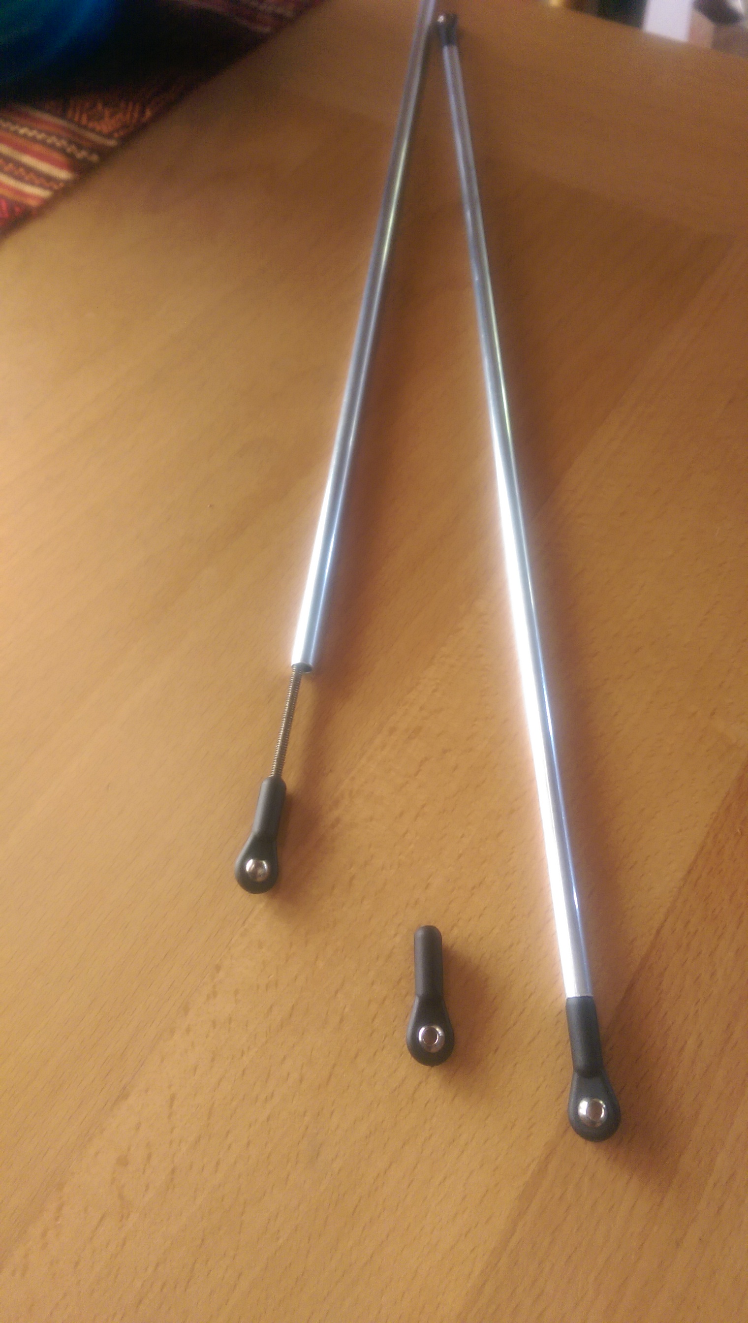 Interrim construction of thrust rods showing ball joints attached to a threaded rod inside an aluminum tube