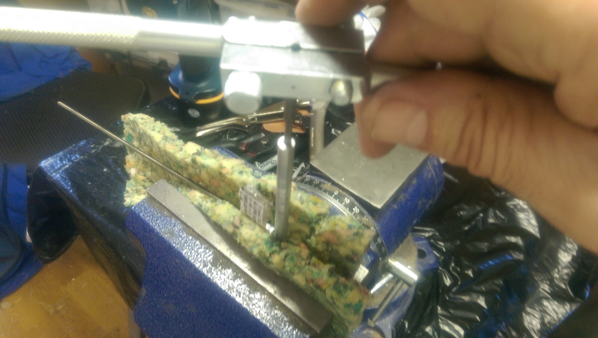 Threading one of the holes with a tap