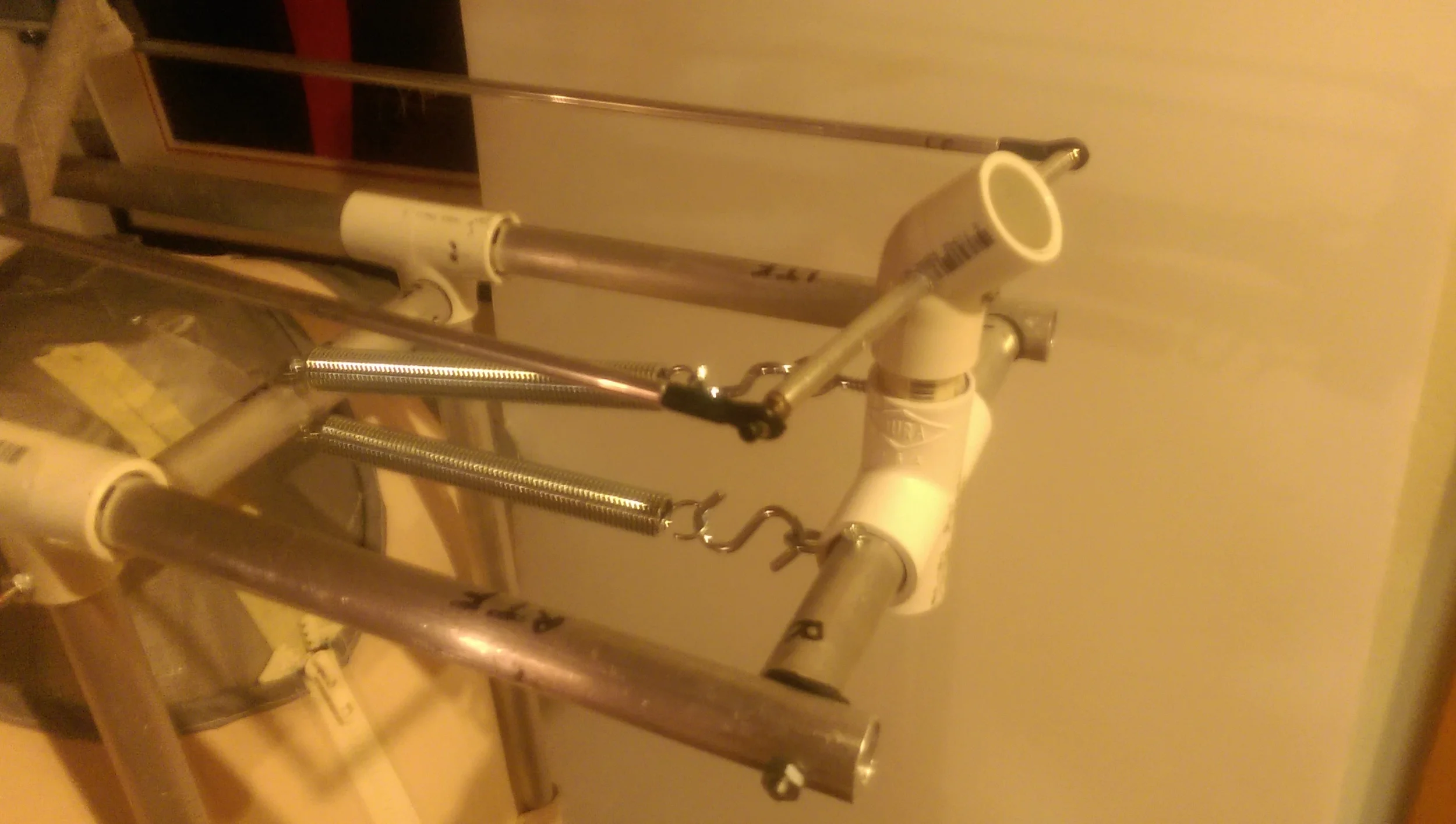 The steering mechanism is installed so that the left/right axis is mounted into the forward/back axis (shown with the counterbalancing springs)