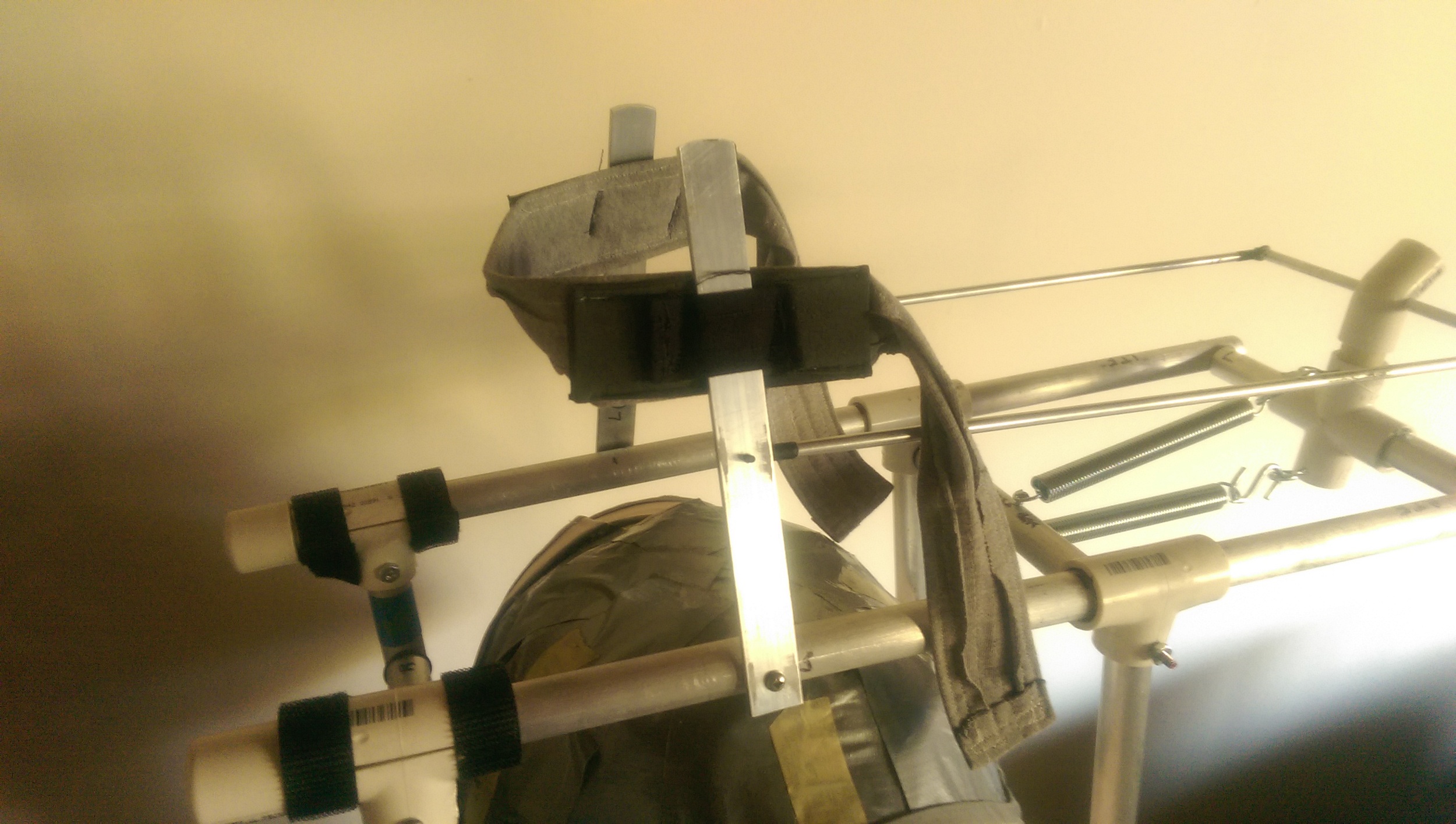 The canvas straps on the padding wrap around the lever arms. The arms can move up & down inside the straps and have some room to twist.
