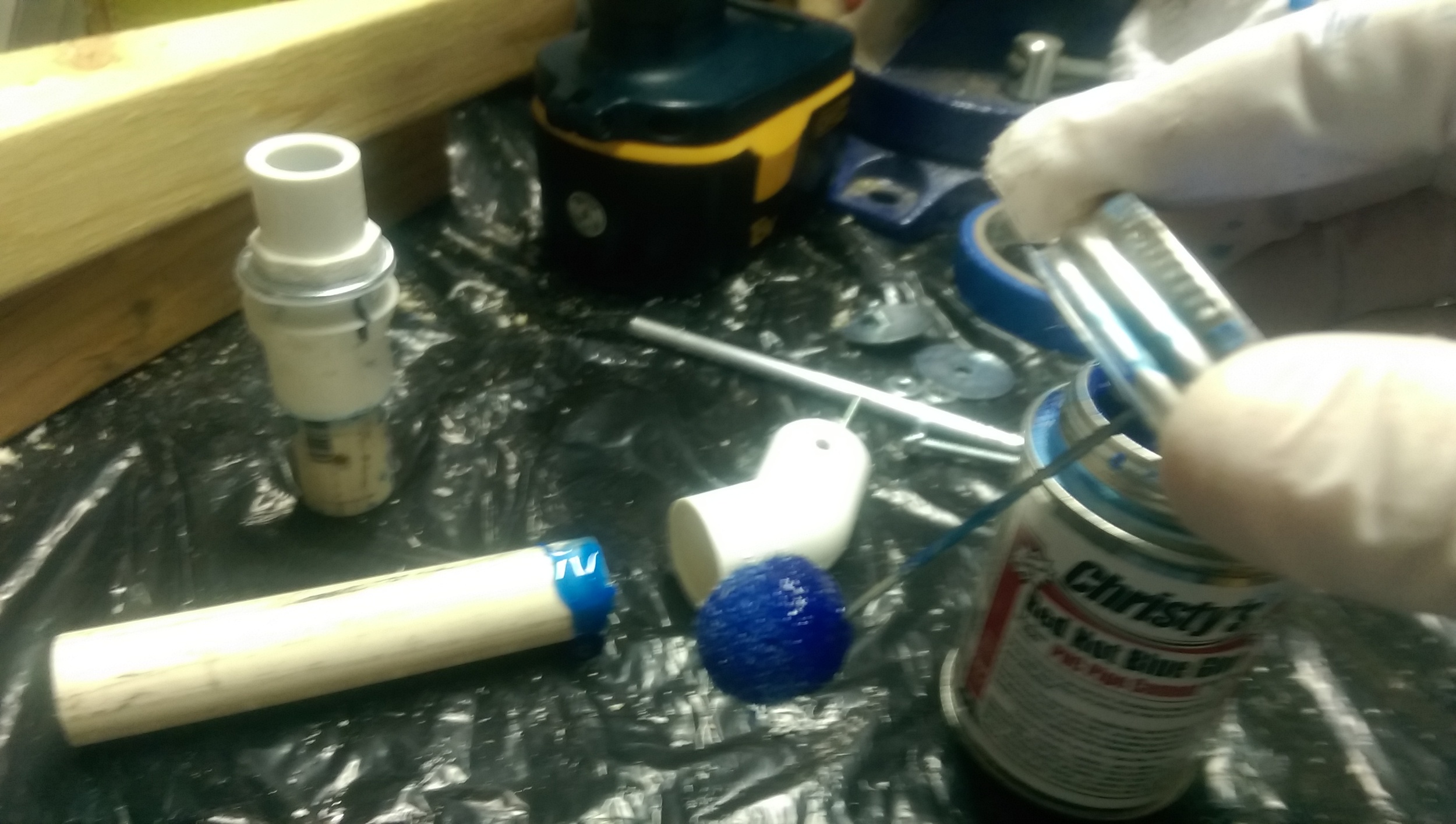 The PVC glued is applied to each end of the tube and then then pressed into the joint. Keeping the joints flat on the table insured they were aligned properly.
