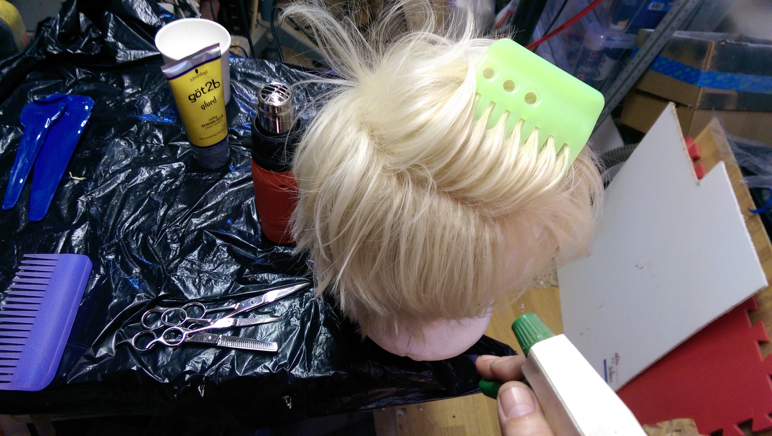 Holding the hair and wetting it down 